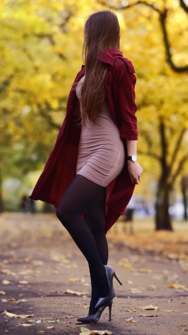 Burgundy long coat, tight black dress, black tights and high heels with ...