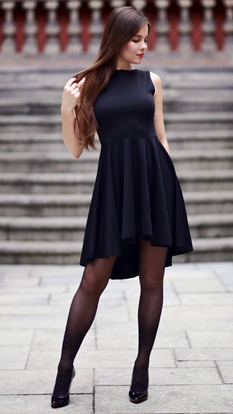 Black dress with long back, black stockings and patent leather heels ...